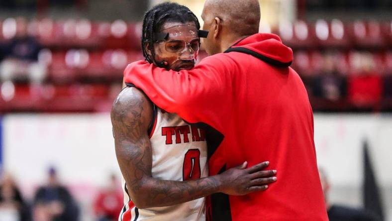 Detroit Mercy guard Antoine Davis (0) hugs head coach Mike Davis after coming off the court during the second half against Wright State at Calihan Hall in Detroit on Saturday, Feb. 25, 2023.