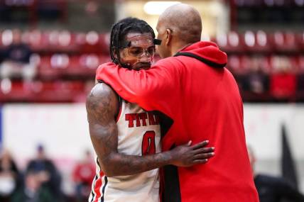 Detroit Mercy guard Antoine Davis (0) hugs head coach Mike Davis after coming off the court during the second half against Wright State at Calihan Hall in Detroit on Saturday, Feb. 25, 2023.