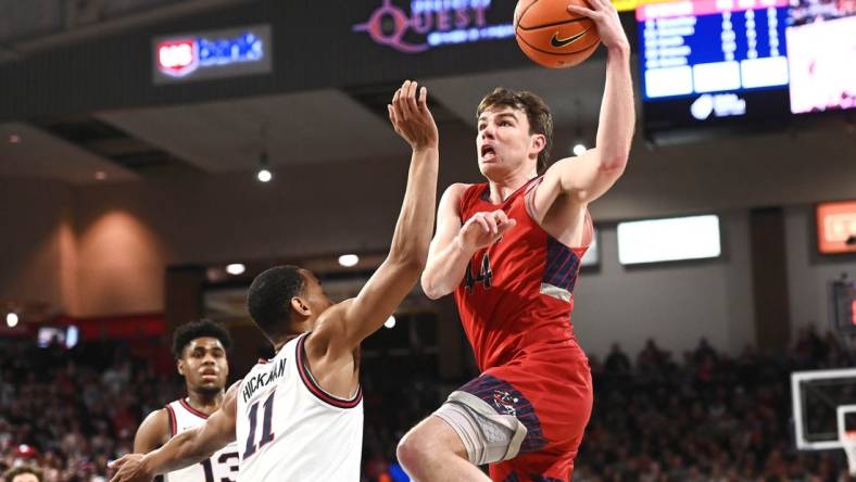 Feb 25, 2023; Spokane, Washington, USA; St. Mary's Gaels guard Alex Ducas (44) shoots the ball against Gonzaga Bulldogs guard Nolan Hickman (11) in the second half at McCarthey Athletic Center. Gonzaga won 77-68. Mandatory Credit: James Snook-USA TODAY Sports