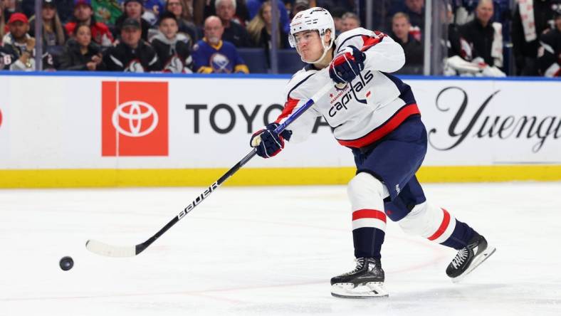 Feb 26, 2023; Buffalo, New York, USA;  Washington Capitals right wing Nicolas Aube-Kubel (96) takes a shot on goal during the first period against the Buffalo Sabres at KeyBank Center. Mandatory Credit: Timothy T. Ludwig-USA TODAY Sports