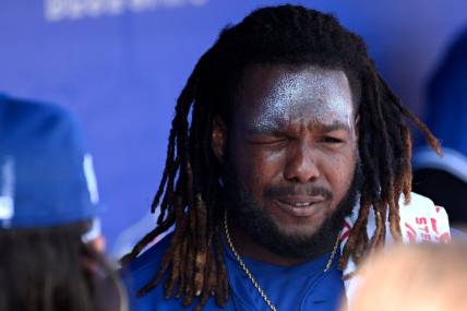 Feb 26, 2023; Dunedin, Florida, USA; Toronto Blue Jays designated hitter Vladimir Guerrero Jr. (27) applies sunscreen before the start of the game against the New York Yankees at TD Ballpark. Mandatory Credit: Jonathan Dyer-USA TODAY Sports