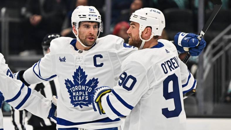 Feb 26, 2023; Seattle, Washington, USA; Toronto Maple Leafs center John Tavares (91) and Toronto Maple Leafs center Ryan O'Reilly (90) celebrate after Tavares scored a goal against the Seattle Kraken during the first period at Climate Pledge Arena. Mandatory Credit: Steven Bisig-USA TODAY Sports