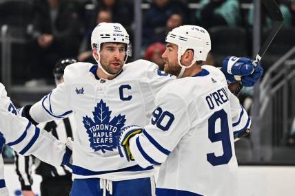 Feb 26, 2023; Seattle, Washington, USA; Toronto Maple Leafs center John Tavares (91) and Toronto Maple Leafs center Ryan O'Reilly (90) celebrate after Tavares scored a goal against the Seattle Kraken during the first period at Climate Pledge Arena. Mandatory Credit: Steven Bisig-USA TODAY Sports
