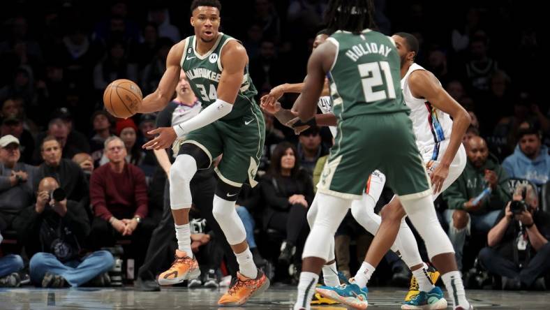 Feb 28, 2023; Brooklyn, New York, USA; Milwaukee Bucks forward Giannis Antetokounmpo (34) looks to pass the ball to guard Jrue Holiday (21) during the first quarter against the Brooklyn Nets at Barclays Center. Mandatory Credit: Brad Penner-USA TODAY Sports