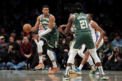 Feb 28, 2023; Brooklyn, New York, USA; Milwaukee Bucks forward Giannis Antetokounmpo (34) looks to pass the ball to guard Jrue Holiday (21) during the first quarter against the Brooklyn Nets at Barclays Center. Mandatory Credit: Brad Penner-USA TODAY Sports