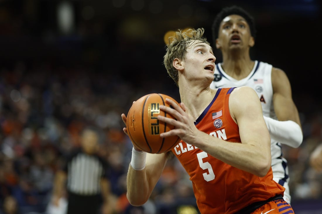 Feb 28, 2023; Charlottesville, Virginia, USA; Clemson Tigers forward Hunter Tyson (5) drives to the basket as Virginia Cavaliers guard Ryan Dunn (13) chases in the first half at John Paul Jones Arena. Mandatory Credit: Geoff Burke-USA TODAY Sports