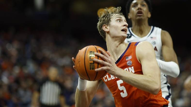 Feb 28, 2023; Charlottesville, Virginia, USA; Clemson Tigers forward Hunter Tyson (5) drives to the basket as Virginia Cavaliers guard Ryan Dunn (13) chases in the first half at John Paul Jones Arena. Mandatory Credit: Geoff Burke-USA TODAY Sports