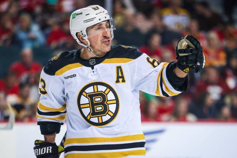 Feb 28, 2023; Calgary, Alberta, CAN; Boston Bruins left wing Brad Marchand (63) reacts during the second period against the Calgary Flames at Scotiabank Saddledome. Mandatory Credit: Sergei Belski-USA TODAY Sports
