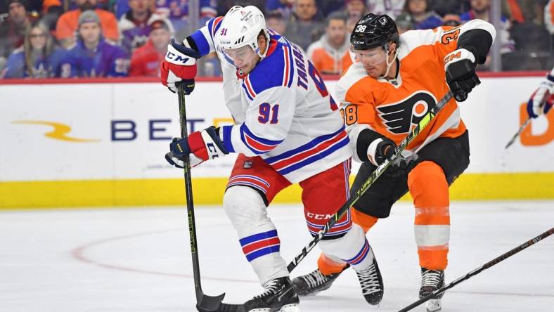 Mar 1, 2023; Philadelphia, Pennsylvania, USA; New York Rangers right wing Vladimir Tarasenko (91) battles for the puck against Philadelphia Flyers center Patrick Brown (38) during the first period at Wells Fargo Center. Mandatory Credit: Eric Hartline-USA TODAY Sports