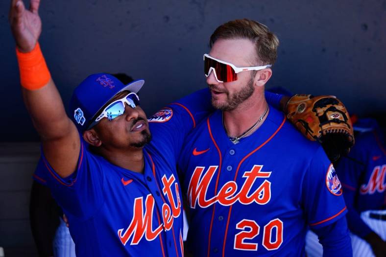 Mar 2, 2023; Port St. Lucie, Florida, USA; New York Mets third baseman Eduardo Escobar (10) and  first baseman Pete Alonso (20) embrace prior to a game against the Atlanta Braves at Clover Park. Mandatory Credit: Rich Storry-USA TODAY Sports