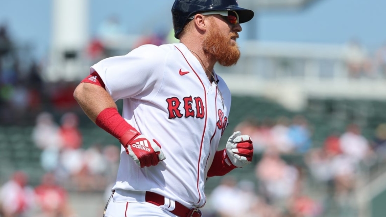 Mar 2, 2023; Fort Myers, Florida, USA; Boston Red Sox third baseman Justin Turner (2) singles during the first inning against the Philadelphia Phillies at JetBlue Park at Fenway South. Mandatory Credit: Kim Klement-USA TODAY Sports