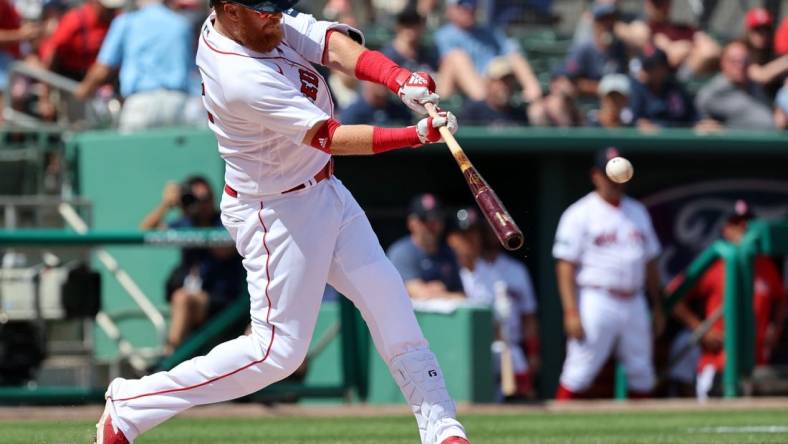 Mar 2, 2023; Fort Myers, Florida, USA;  Boston Red Sox third baseman Justin Turner (2) singles during the third inning against the Philadelphia Phillies at JetBlue Park at Fenway South. Mandatory Credit: Kim Klement-USA TODAY Sports