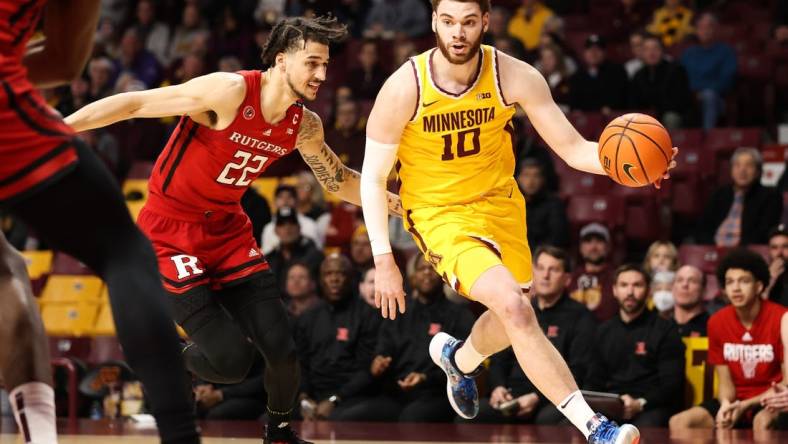 Mar 2, 2023; Minneapolis, Minnesota, USA; Minnesota Golden Gophers forward Jamison Battle (10) drives to the basket while Rutgers Scarlet Knights guard Caleb McConnell (22) defends during the first half at Williams Arena. Mandatory Credit: Matt Krohn-USA TODAY Sports