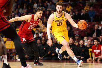 Mar 2, 2023; Minneapolis, Minnesota, USA; Minnesota Golden Gophers forward Jamison Battle (10) drives to the basket while Rutgers Scarlet Knights guard Caleb McConnell (22) defends during the first half at Williams Arena. Mandatory Credit: Matt Krohn-USA TODAY Sports