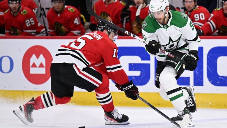 Mar 2, 2023; Chicago, Illinois, USA;  Dallas Stars forward Tyler Seguin (91) dekes around Chicago Blackhawks forward Joey Anderson (15) in the second period at United Center. Mandatory Credit: Jamie Sabau-USA TODAY Sports