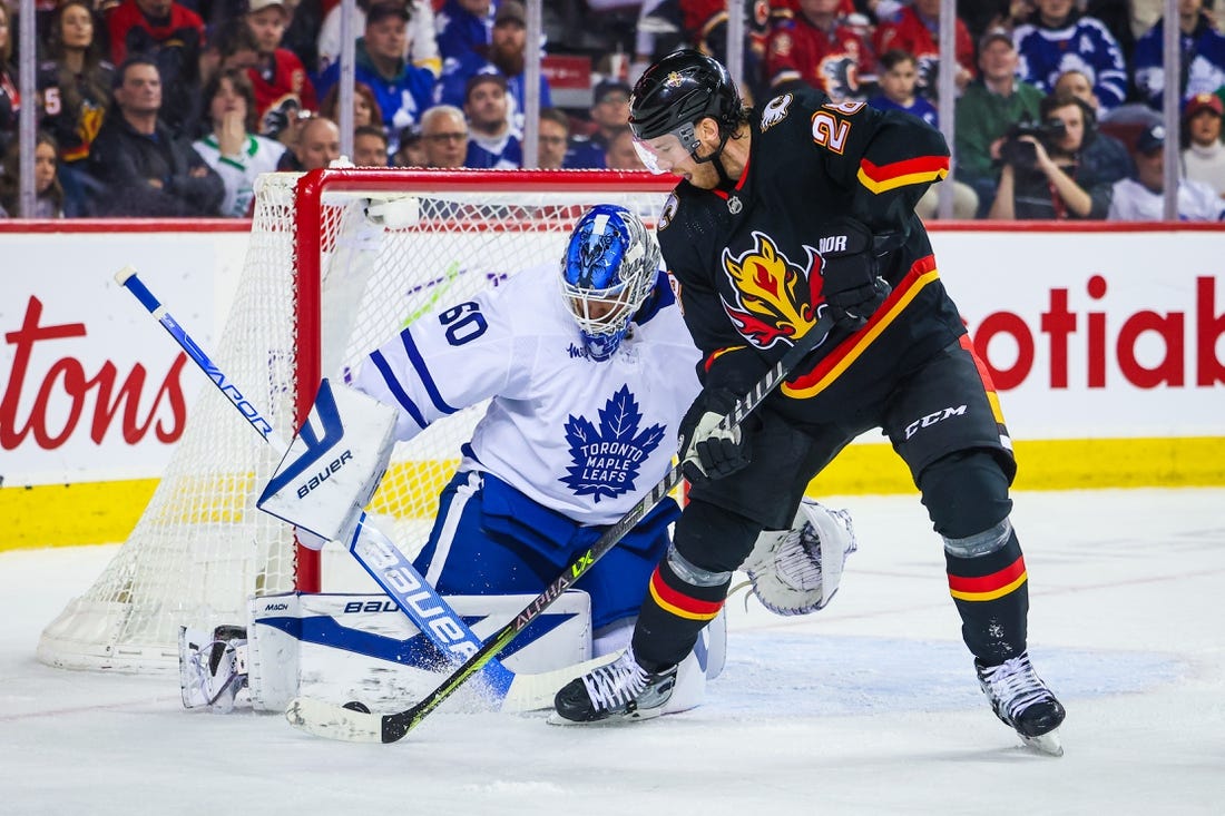 Mar 2, 2023; Calgary, Alberta, CAN; Toronto Maple Leafs goaltender Joseph Woll (60) makes a save against Calgary Flames center Elias Lindholm (28) during the second period at Scotiabank Saddledome. Mandatory Credit: Sergei Belski-USA TODAY Sports