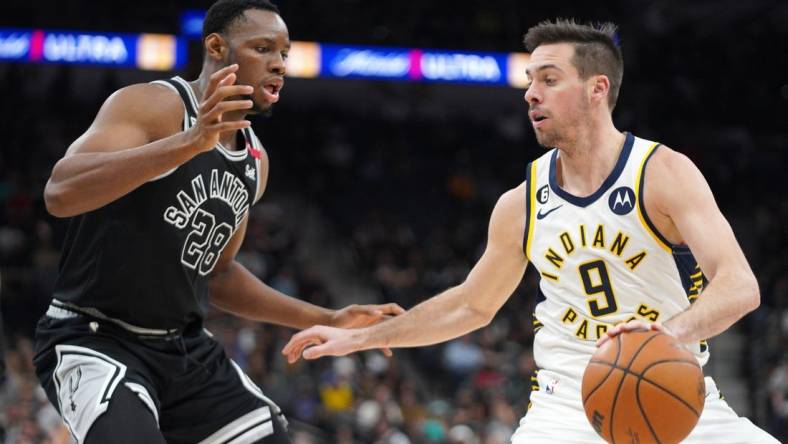 Mar 2, 2023; San Antonio, Texas, USA; Indiana Pacers guard T.J. McConnell (9) dribble against San Antonio Spurs center Charles Bassey (28) during the third quarter in a 110-99 Spurs win at AT&T Center. Mandatory Credit: Dustin Safranek-USA TODAY Sports