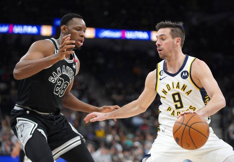 Mar 2, 2023; San Antonio, Texas, USA; Indiana Pacers guard T.J. McConnell (9) dribble against San Antonio Spurs center Charles Bassey (28) during the third quarter in a 110-99 Spurs win at AT&T Center. Mandatory Credit: Dustin Safranek-USA TODAY Sports