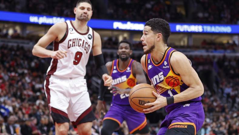 Mar 3, 2023; Chicago, Illinois, USA; Phoenix Suns guard Devin Booker (1) drives to the basket against the Chicago Bulls during the first half at United Center. Mandatory Credit: Kamil Krzaczynski-USA TODAY Sports