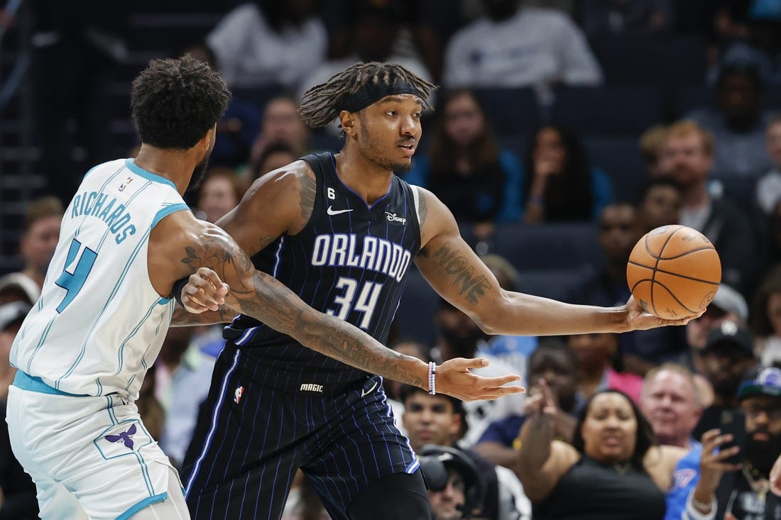 Mar 3, 2023; Charlotte, North Carolina, USA; Orlando Magic center Wendell Carter Jr. (34) looks to pass against Charlotte Hornets center Nick Richards (4) during the second half at Spectrum Center. Mandatory Credit: Nell Redmond-USA TODAY Sports