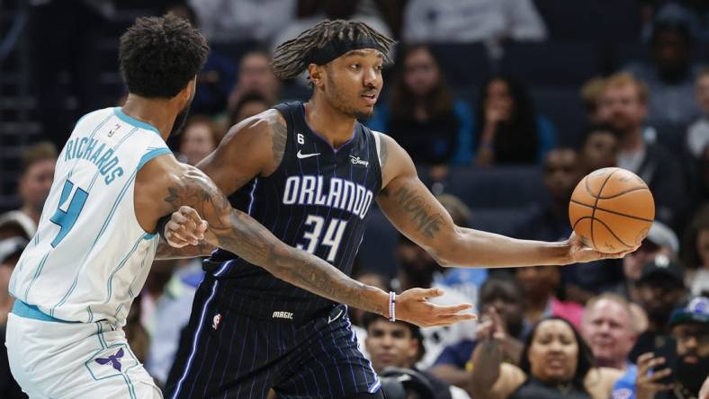 Mar 3, 2023; Charlotte, North Carolina, USA; Orlando Magic center Wendell Carter Jr. (34) looks to pass against Charlotte Hornets center Nick Richards (4) during the second half at Spectrum Center. Mandatory Credit: Nell Redmond-USA TODAY Sports