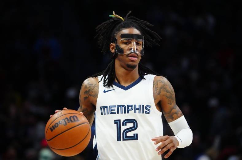 Mar 3, 2023; Denver, Colorado, USA; Memphis Grizzlies guard Ja Morant (12) dribbles during the first quarter against the Denver Nuggets at Ball Arena. Mandatory Credit: Ron Chenoy-USA TODAY Sports