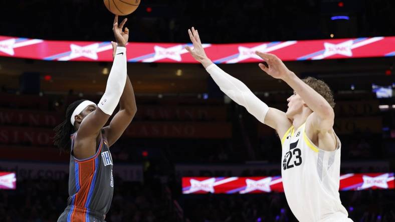 Mar 3, 2023; Oklahoma City, Oklahoma, USA; Oklahoma City Thunder guard Luguentz Dort (5) shoots a three point basket against Utah Jazz forward Lauri Markkanen (23) during the first quarter at Paycom Center. Mandatory Credit: Alonzo Adams-USA TODAY Sports