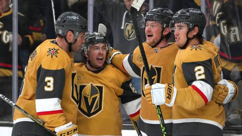 Mar 3, 2023; Las Vegas, Nevada, USA; Vegas Golden Knights center Jack Eichel (9) celebrates with defenseman Brayden McNabb (3), right wing Jonathan Marchessault (81), and  defenseman Zach Whitecloud (2) after scoring a goal against the New Jersey Devils during the third period at T-Mobile Arena. Mandatory Credit: Stephen R. Sylvanie-USA TODAY Sports