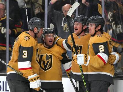 Mar 3, 2023; Las Vegas, Nevada, USA; Vegas Golden Knights center Jack Eichel (9) celebrates with defenseman Brayden McNabb (3), right wing Jonathan Marchessault (81), and  defenseman Zach Whitecloud (2) after scoring a goal against the New Jersey Devils during the third period at T-Mobile Arena. Mandatory Credit: Stephen R. Sylvanie-USA TODAY Sports