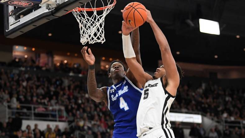 Mar 4, 2023; Providence, Rhode Island, USA; Seton Hall Pirates forward Tyrese Samuel (4) defends the basket from Providence Friars forward Ed Croswell (5) during the first half at Amica Mutual Pavilion. Mandatory Credit: Eric Canha-USA TODAY Sports