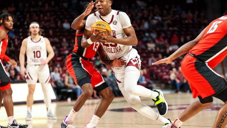 Mar 4, 2023; Columbia, South Carolina, USA; South Carolina Gamecocks forward Gregory Jackson II (23) drives around Georgia Bulldogs guard Mardrez McBride (13) in the first half at Colonial Life Arena. Mandatory Credit: Jeff Blake-USA TODAY Sports