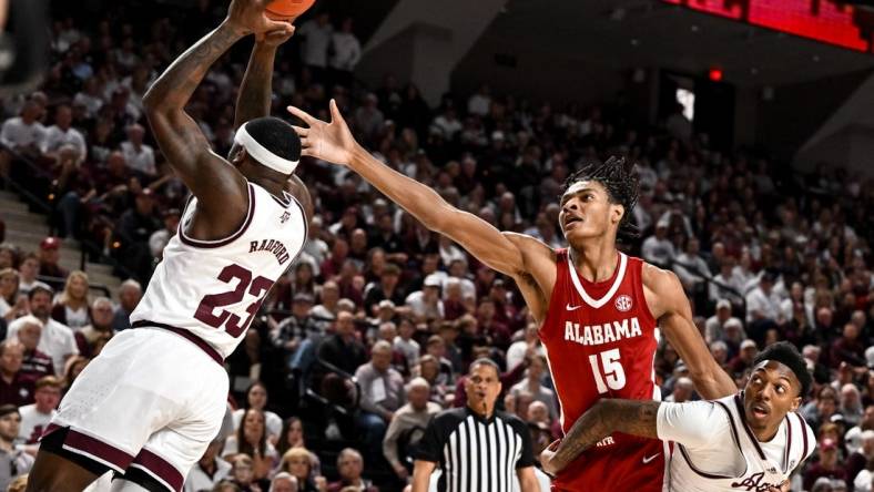 Mar 4, 2023; College Station, Texas, USA; Alabama Crimson Tide forward Noah Clowney (15) fights for a rebound against Texas A&M Aggies guard Tyrece Radford (23) and guard Wade Taylor IV (4) during the first half at Reed Arena. Mandatory Credit: Maria Lysaker-USA TODAY Sports