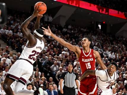 Mar 4, 2023; College Station, Texas, USA; Alabama Crimson Tide forward Noah Clowney (15) fights for a rebound against Texas A&M Aggies guard Tyrece Radford (23) and guard Wade Taylor IV (4) during the first half at Reed Arena. Mandatory Credit: Maria Lysaker-USA TODAY Sports