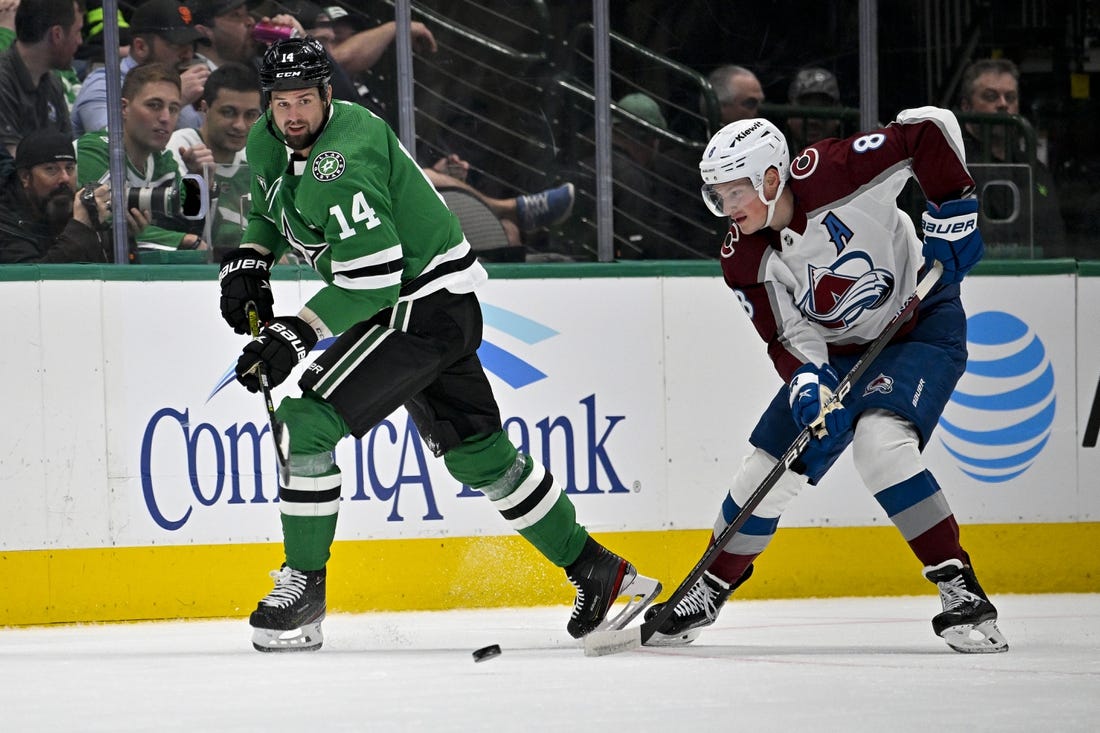 Mar 4, 2023; Dallas, Texas, USA; Dallas Stars left wing Jamie Benn (14) passes the puck in front of Colorado Avalanche defenseman Cale Makar (8) during the first period at the American Airlines Center. Mandatory Credit: Jerome Miron-USA TODAY Sports