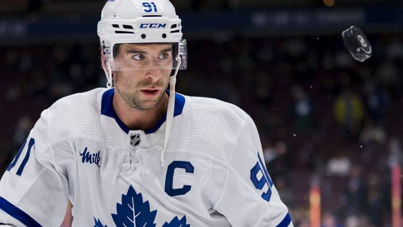 Mar 4, 2023; Vancouver, British Columbia, CAN; Toronto Maple Leafs forward John Tavares (91) handles the puck  during warm up prior to a game against the Vancouver Canucks at Rogers Arena. Mandatory Credit: Bob Frid-USA TODAY Sports