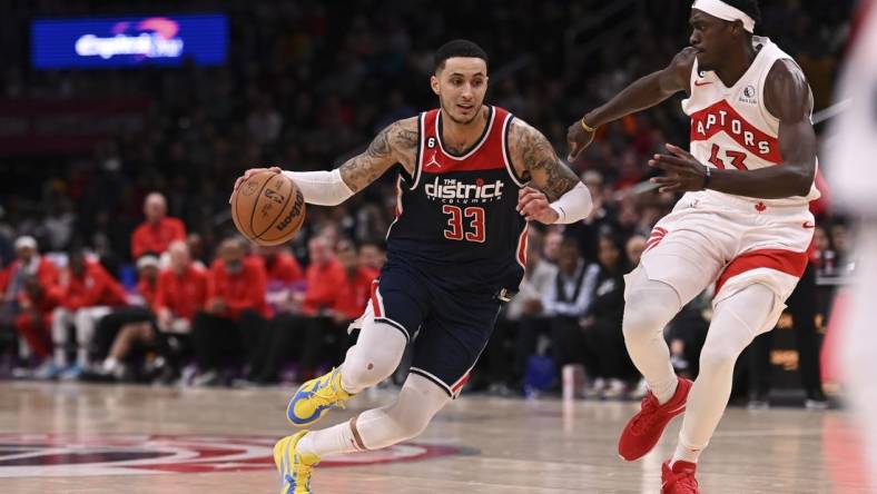 Mar 4, 2023; Washington, District of Columbia, USA;  Washington Wizards forward Kyle Kuzma (33) makes a move to the basket as Toronto Raptors forward Pascal Siakam (43) defends during the during over time at Capital One Arena. Mandatory Credit: Tommy Gilligan-USA TODAY Sports