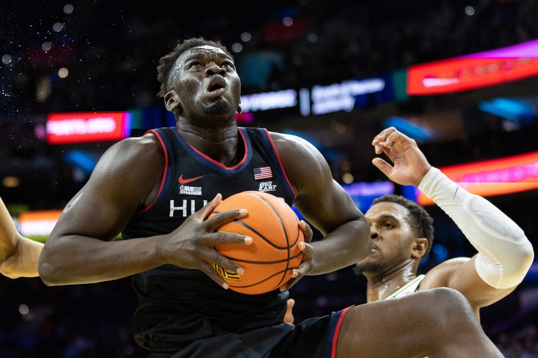 Mar 4, 2023; Philadelphia, Pennsylvania, USA; Connecticut Huskies forward Adama Sanogo (21) rebounds the ball in front of Villanova Wildcats forward Eric Dixon (43) during the first half at Wells Fargo Center. Mandatory Credit: Bill Streicher-USA TODAY Sports