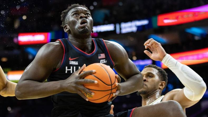 Mar 4, 2023; Philadelphia, Pennsylvania, USA; Connecticut Huskies forward Adama Sanogo (21) rebounds the ball in front of Villanova Wildcats forward Eric Dixon (43) during the first half at Wells Fargo Center. Mandatory Credit: Bill Streicher-USA TODAY Sports