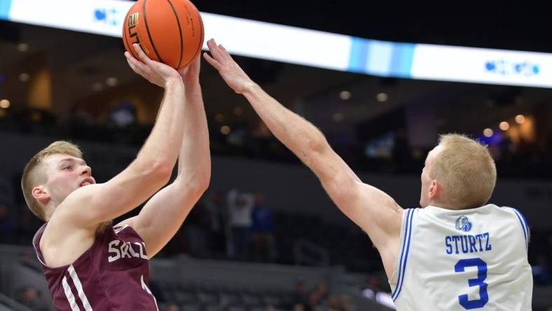 Mar 4, 2023; St. Louis, MO, USA;  Southern Illinois Salukis forward Marcus Domask (1) shoots over Drake Bulldogs guard Garrett Sturtz (3) during the second half at Enterprise Center. Mandatory Credit: Ron Johnson-USA TODAY Sports