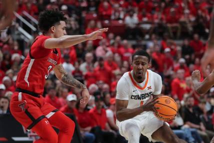 Mar 4, 2023; Lubbock, Texas, USA;  Oklahoma State Cowboys guard Bryce Thompson (1) works the ball against Texas Tech Red Raiders guard D   Maurian Williams (3) in the second half at United Supermarkets Arena. Mandatory Credit: Michael C. Johnson-USA TODAY Sports
