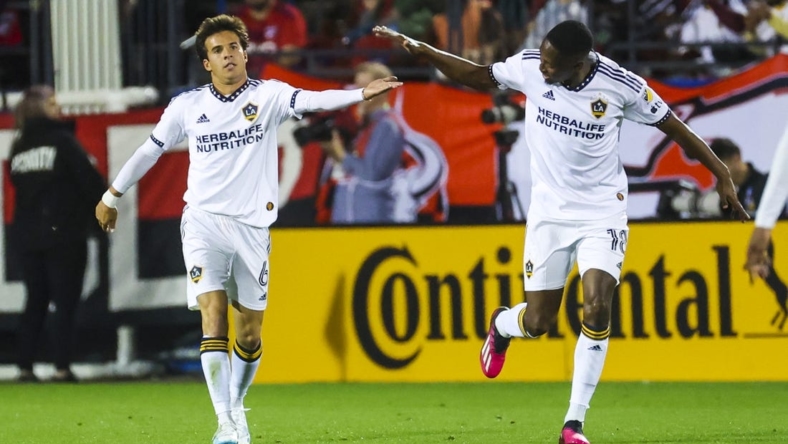 Mar 4, 2023; Frisco, Texas, USA;  Los Angeles Galaxy midfielder Riqui Puig (6) celebrates with Los Angeles Galaxy defender Kelvin Leerdam (18) after scoring a goal during the first half against FC Dallas at Toyota Stadium. Mandatory Credit: Kevin Jairaj-USA TODAY Sports