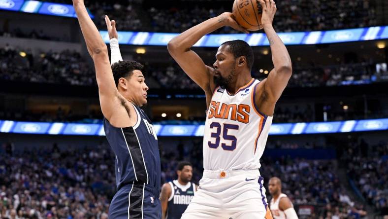 Mar 5, 2023; Dallas, Texas, USA; Phoenix Suns forward Kevin Durant (35) looks to pass the ball around Dallas Mavericks guard Josh Green (8) during the first quarter at the American Airlines Center. Mandatory Credit: Jerome Miron-USA TODAY Sports