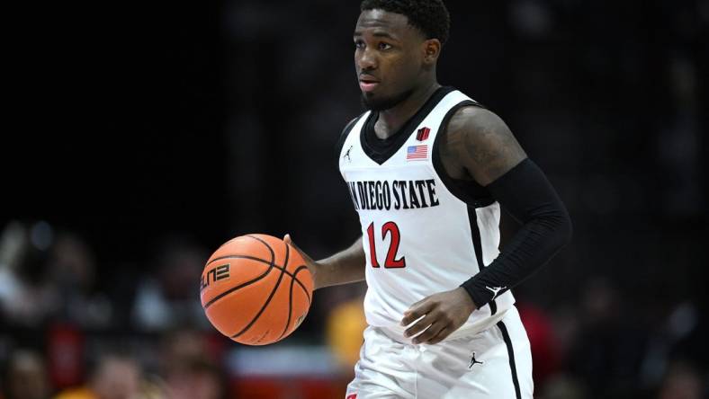 Mar 4, 2023; San Diego, California, USA; San Diego State Aztecs guard Darrion Trammell (12) dribbles the ball during the second half against the Wyoming Cowboys at Viejas Arena. Mandatory Credit: Orlando Ramirez-USA TODAY Sports