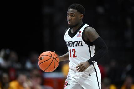 Mar 4, 2023; San Diego, California, USA; San Diego State Aztecs guard Darrion Trammell (12) dribbles the ball during the second half against the Wyoming Cowboys at Viejas Arena. Mandatory Credit: Orlando Ramirez-USA TODAY Sports