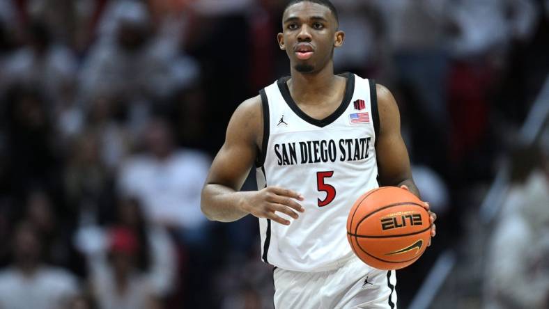 Mar 4, 2023; San Diego, California, USA; San Diego State Aztecs guard Lamont Butler (5) dribbles the ball during the second half against the Wyoming Cowboys at Viejas Arena. Mandatory Credit: Orlando Ramirez-USA TODAY Sports