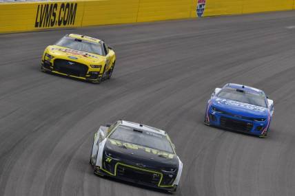 Mar 5, 2023; Las Vegas, Nevada, USA; NASCAR Cup Series driver William Byron (24) leads driver Joey Logano (22) and driver Kyle Larson (5) during the Pennzoil 400 at Las Vegas Motor Speedway. Mandatory Credit: Gary A. Vasquez-USA TODAY Sports