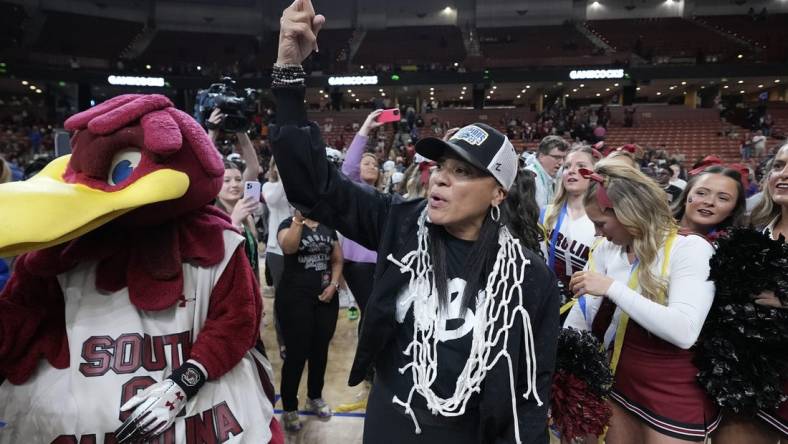 Mar 5, 2023; Greenville, SC, USA; South Carolina Gamecocks head coach Dawn Staley wears the net rounder neck and flashes a number on to the crowd after winning the SEC Championship at Bon Secours Wellness Arena. Mandatory Credit: David Yeazell-USA TODAY Sports