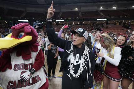 Mar 5, 2023; Greenville, SC, USA; South Carolina Gamecocks head coach Dawn Staley wears the net rounder neck and flashes a number on to the crowd after winning the SEC Championship at Bon Secours Wellness Arena. Mandatory Credit: David Yeazell-USA TODAY Sports