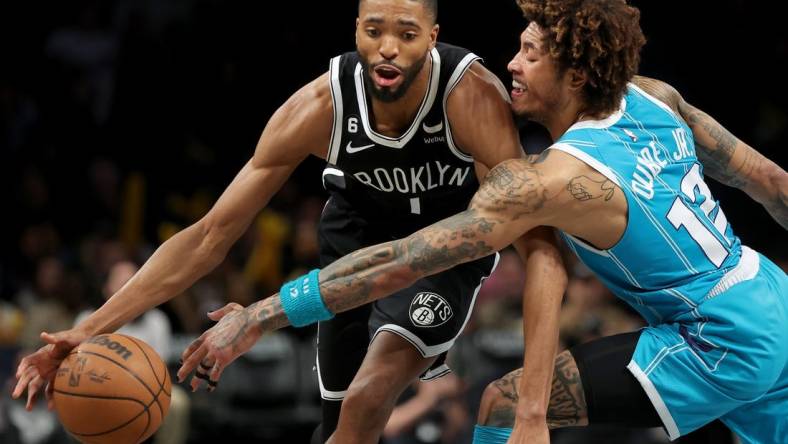 Mar 5, 2023; Brooklyn, New York, USA; Brooklyn Nets forward Mikal Bridges (1) drives to the basket against Charlotte Hornets guard Kelly Oubre Jr. (12) during the fourth quarter at Barclays Center. Mandatory Credit: Brad Penner-USA TODAY Sports