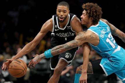 Mar 5, 2023; Brooklyn, New York, USA; Brooklyn Nets forward Mikal Bridges (1) drives to the basket against Charlotte Hornets guard Kelly Oubre Jr. (12) during the fourth quarter at Barclays Center. Mandatory Credit: Brad Penner-USA TODAY Sports